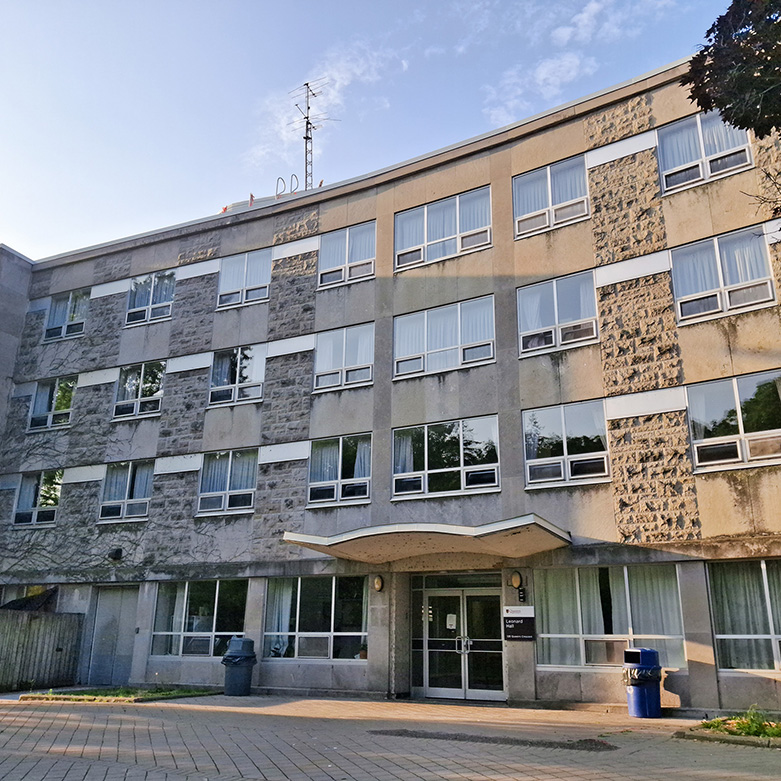 Leonard Hall exterior—four-storey stone and concrete façade with central entrance at Queen’s University.