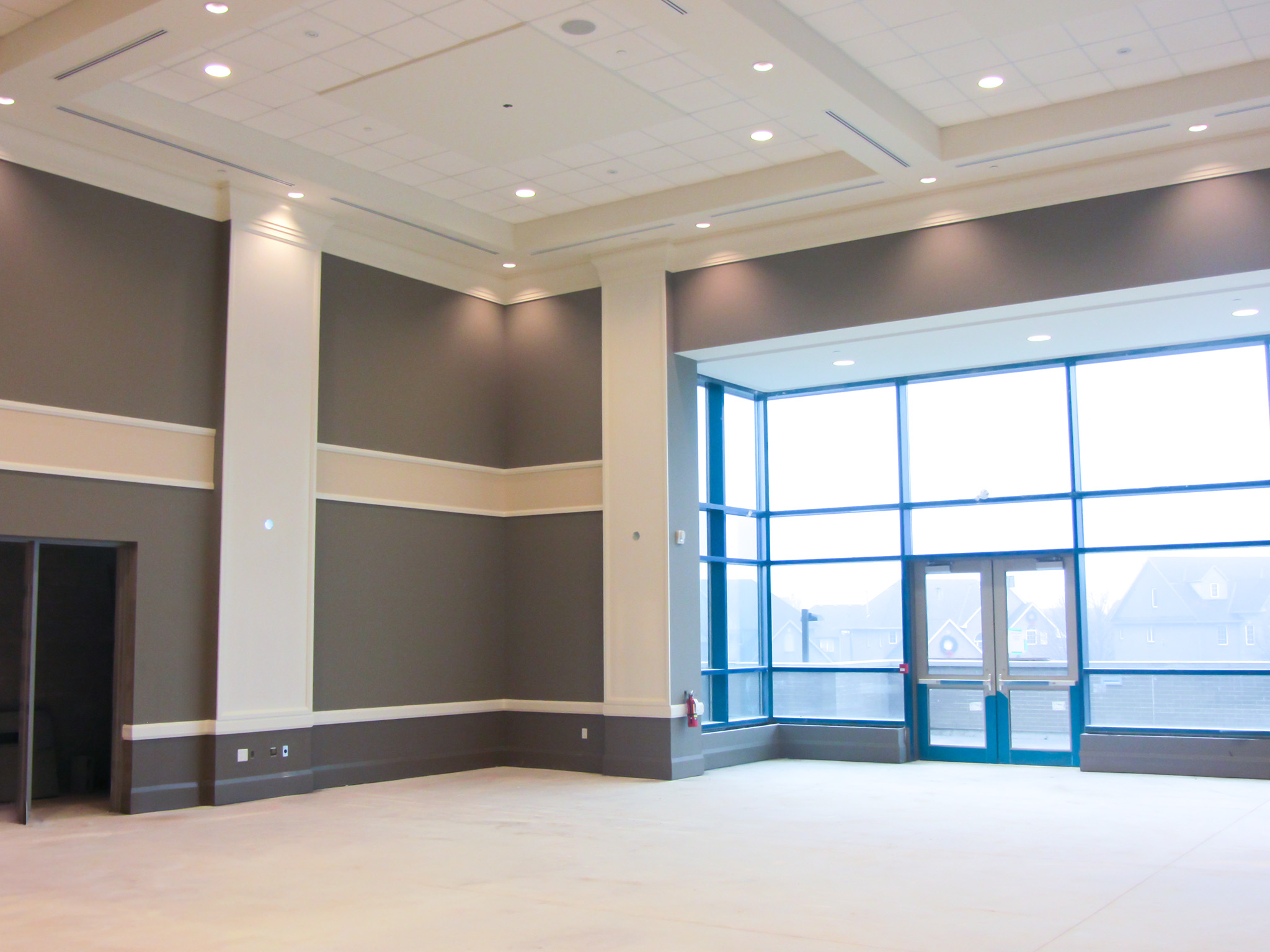 Interior of a large banquet hall at St. Joseph’s Ukrainian Catholic Church with high ceilings, neutral walls, and tall windows letting in natural light.