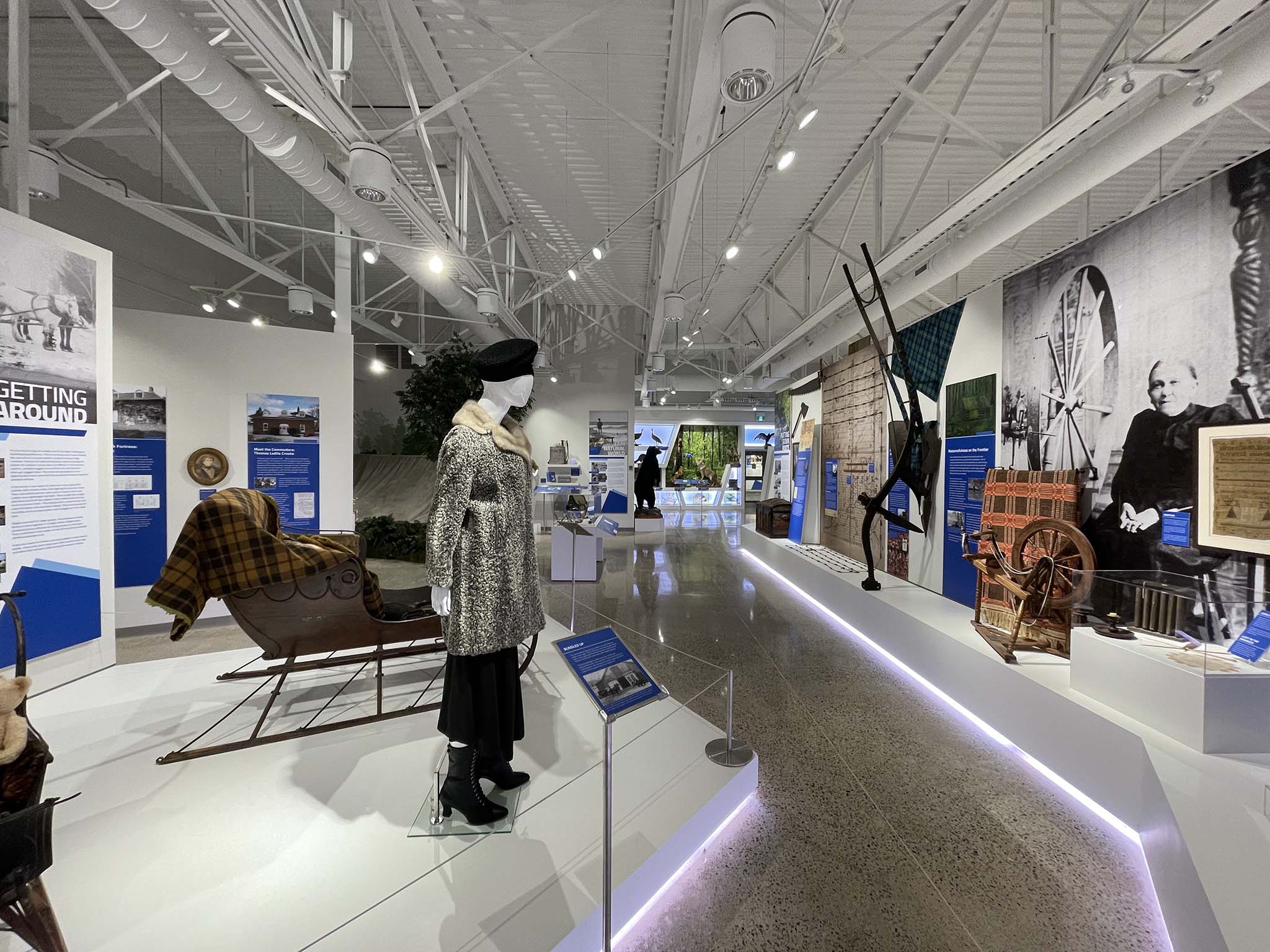 Exhibit at Lambton Heritage Museum with historic clothing, sleigh, and artifacts on display.