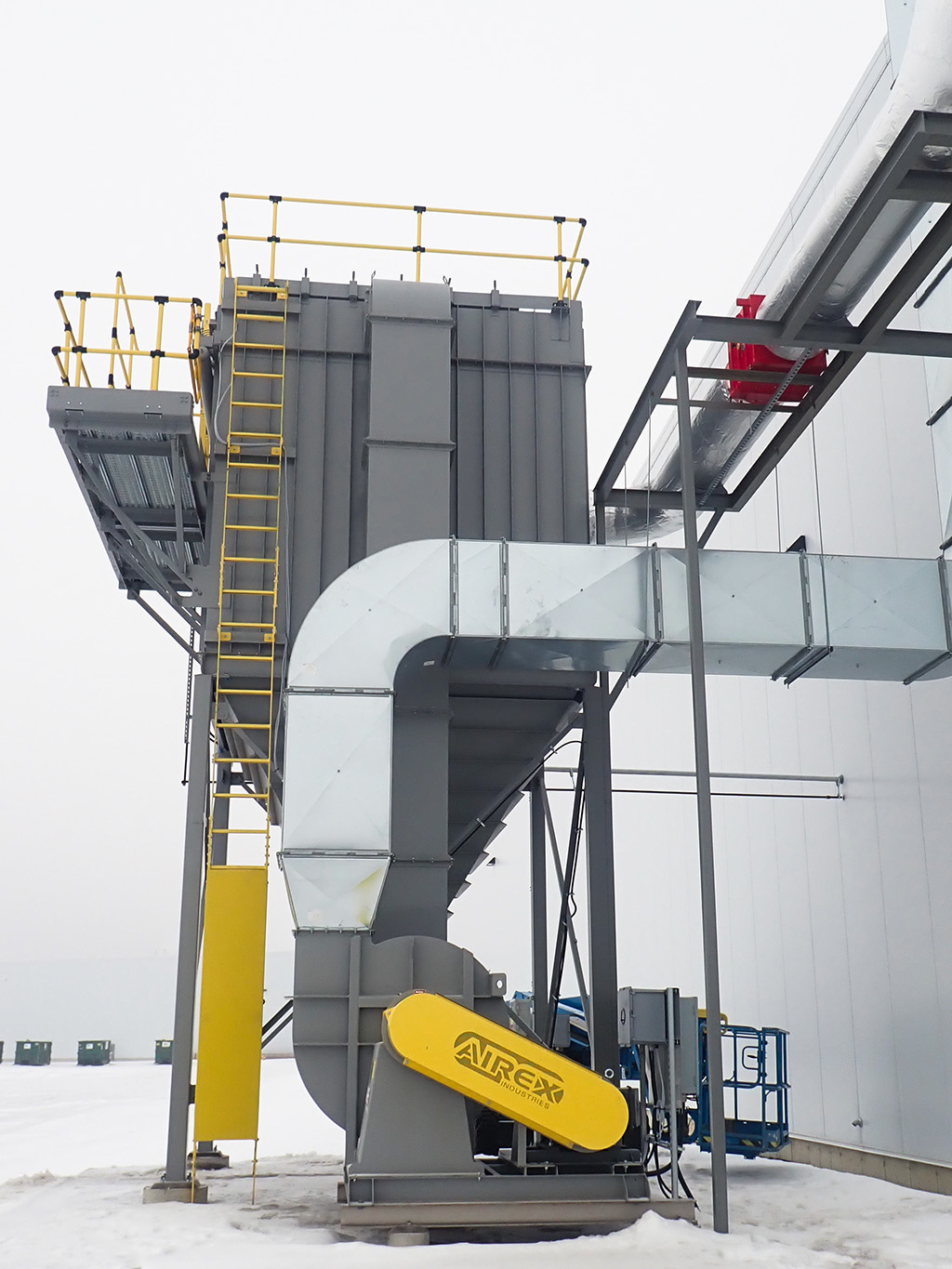 Norbec Industrial 12 ChatGPT said: Alt text: Exterior view of a large grey air handling and filtration unit with yellow safety rails and ductwork at Norbec’s Strathroy facility.