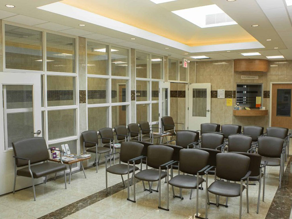 Springbank Medical 3 Waiting area inside Springbank Medical Centre with rows of chairs, tiled flooring, and a skylight ceiling.