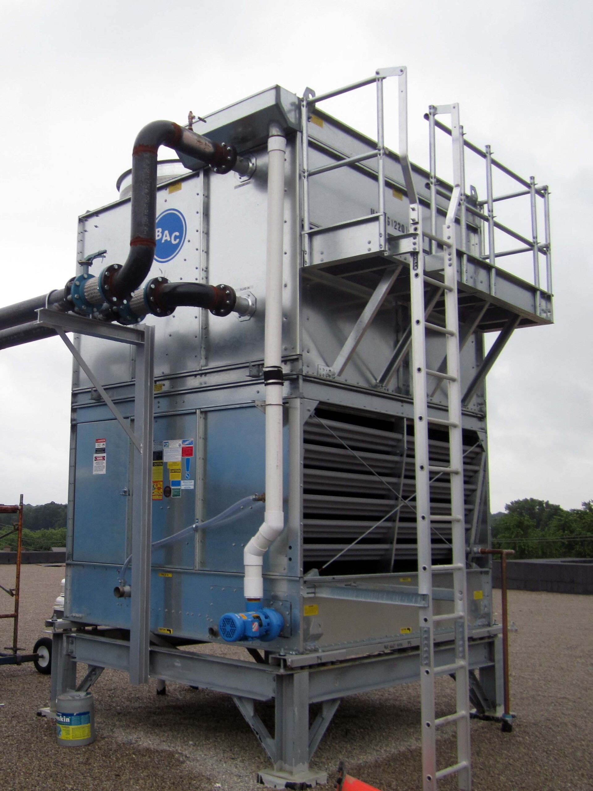 Springbank Medical 4 Rooftop cooling tower unit with connected piping and access ladder at Springbank Medical Centre.