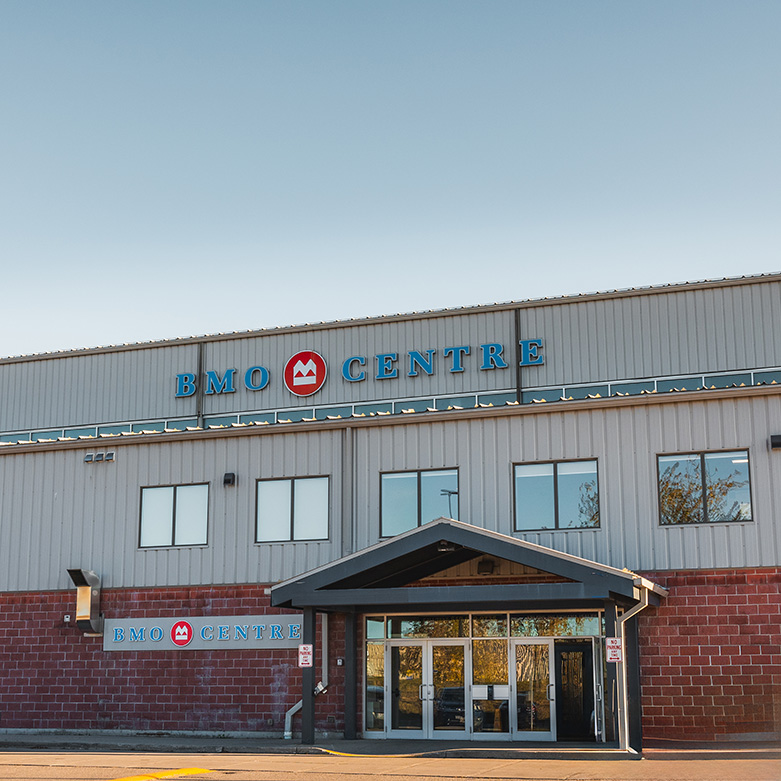 BMO Centre Exterior view of the BMO Centre building, showing the main entrance beneath a peaked canopy and the facility’s name displayed on the upper façade.
